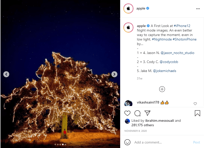 Instagram post of man standing under tree with fairy lights at night